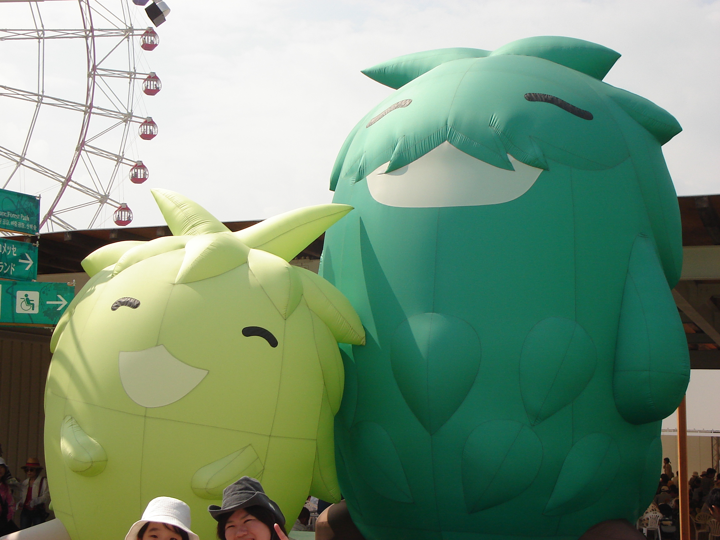inflatable mascot characters that look like tall and short green shrubs