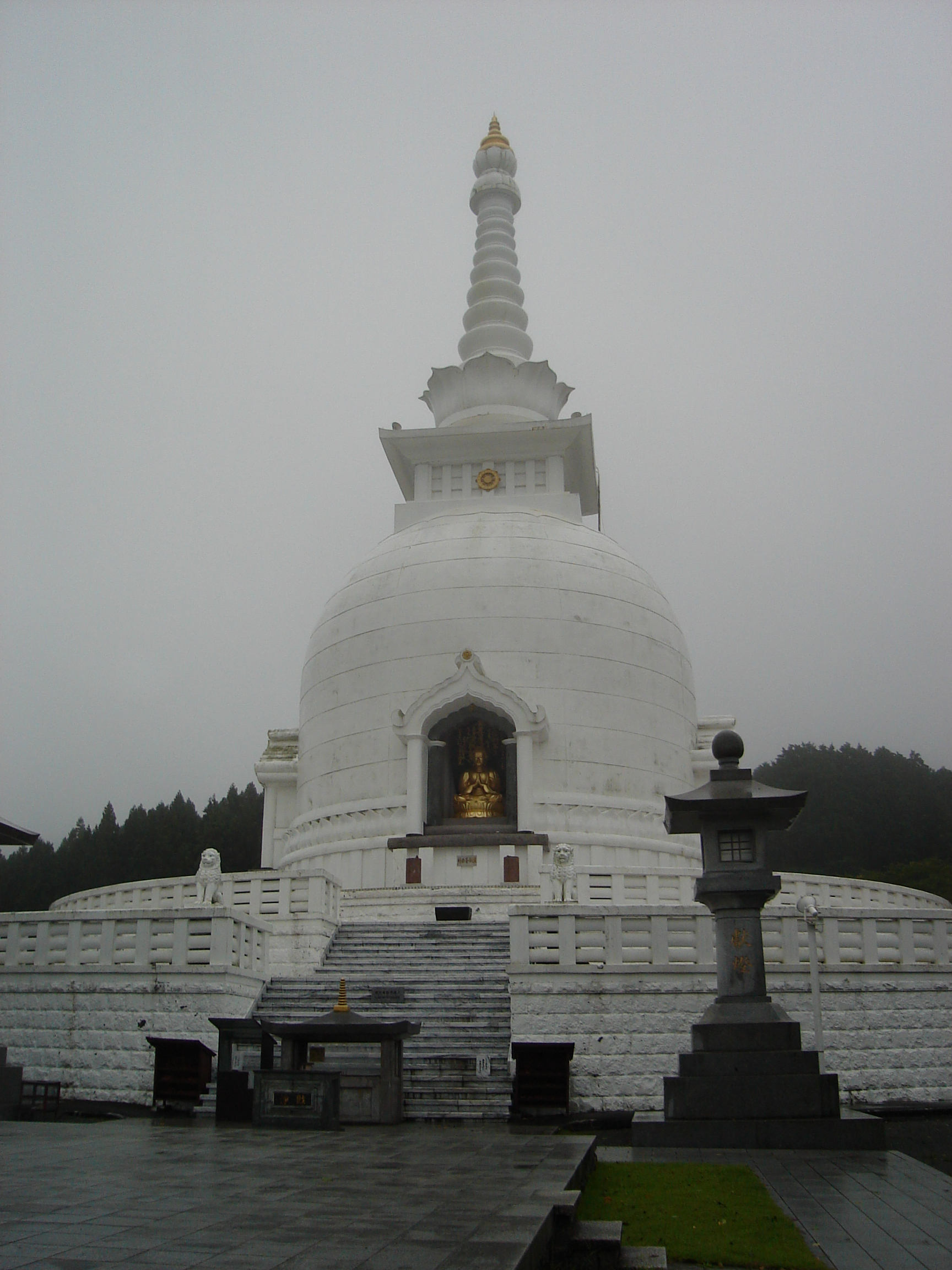 white dome with a spire and gold statue
