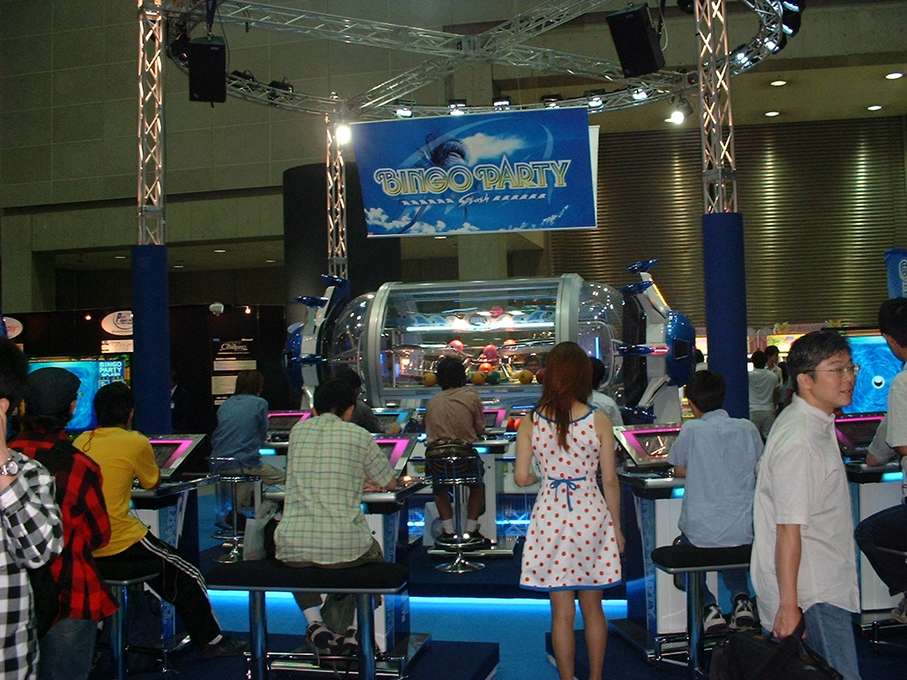 people sit on stools around a large area game called bingo party