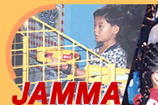 a japanese woman plays some type of shooting game above the acronym JAMMA