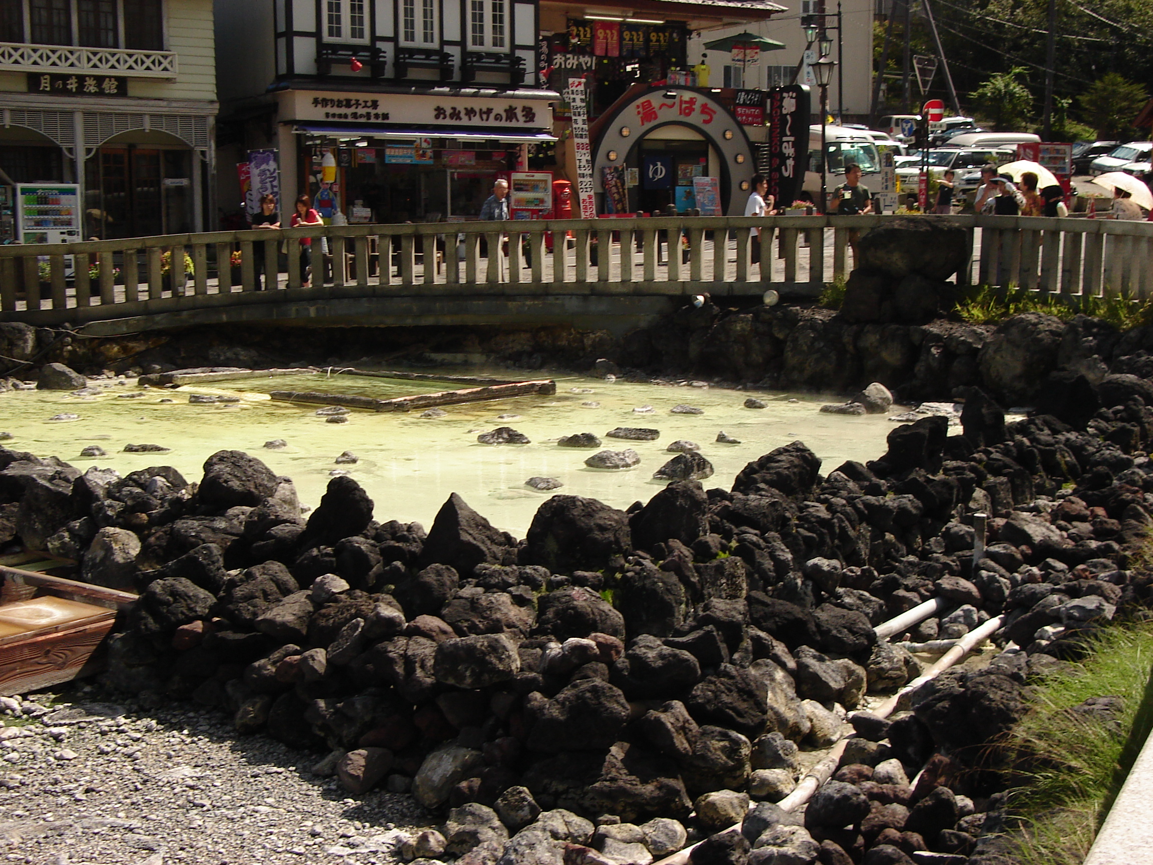 the main hot spring in the centre of town with shops in the background