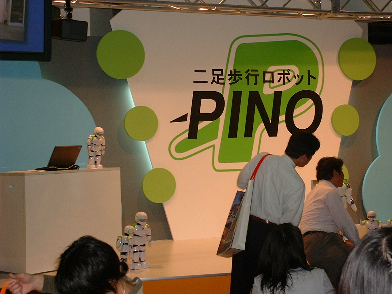 small robots on display near the pino logo