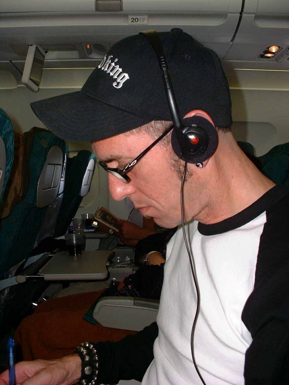 a middle aged white man wearing a cap and headphones