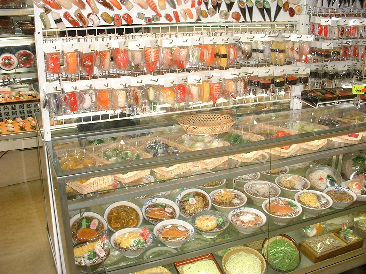 a display of fake bowls of food and individual items