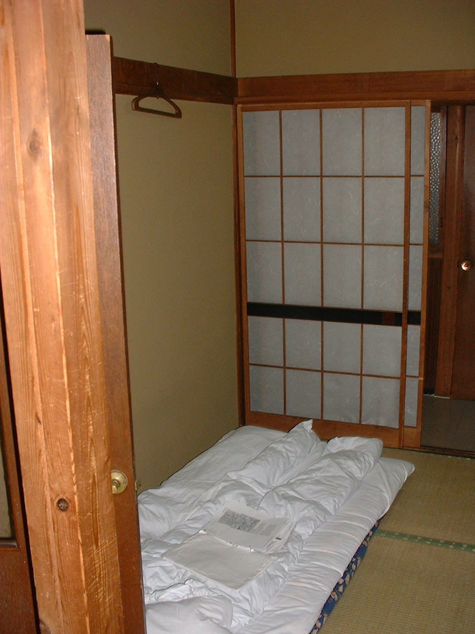 a futon near a paper screen door