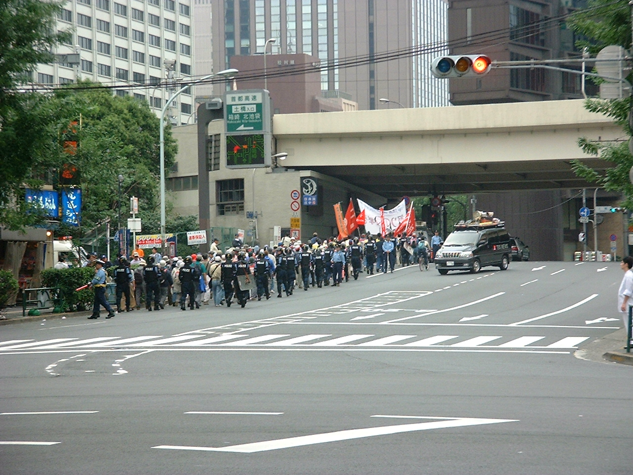 police officers escort the line of protesters