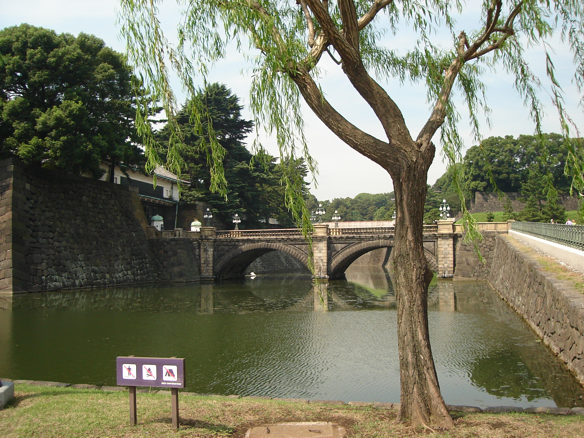 a corner of the moat and the arched bridge to the garden entrance