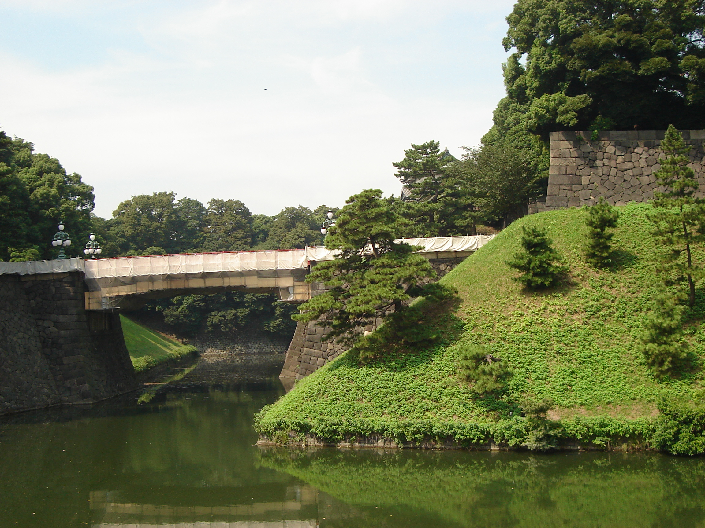the bridge and a grassy portion of the moat wall