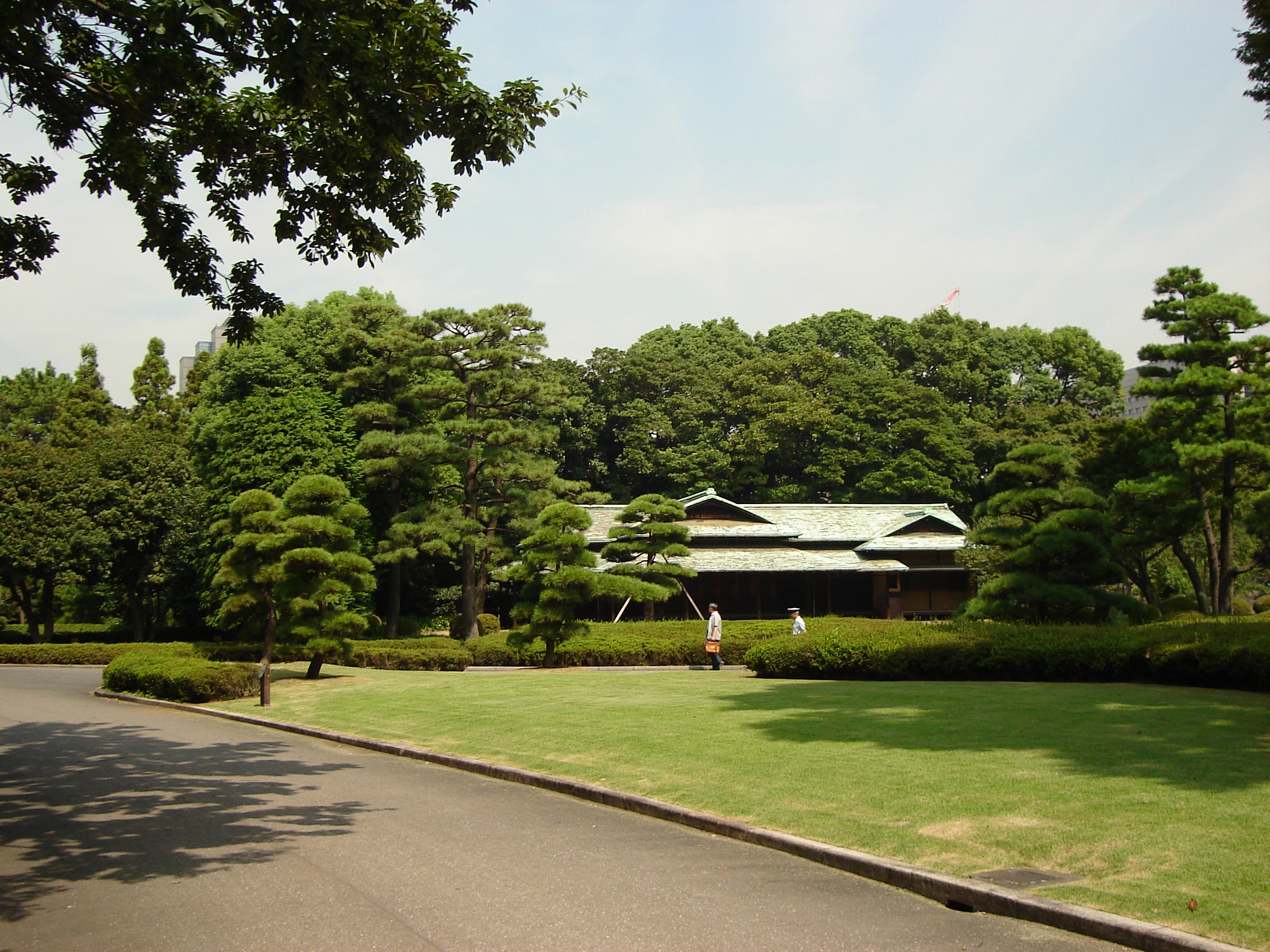 a building in the distance surrounded by trees
