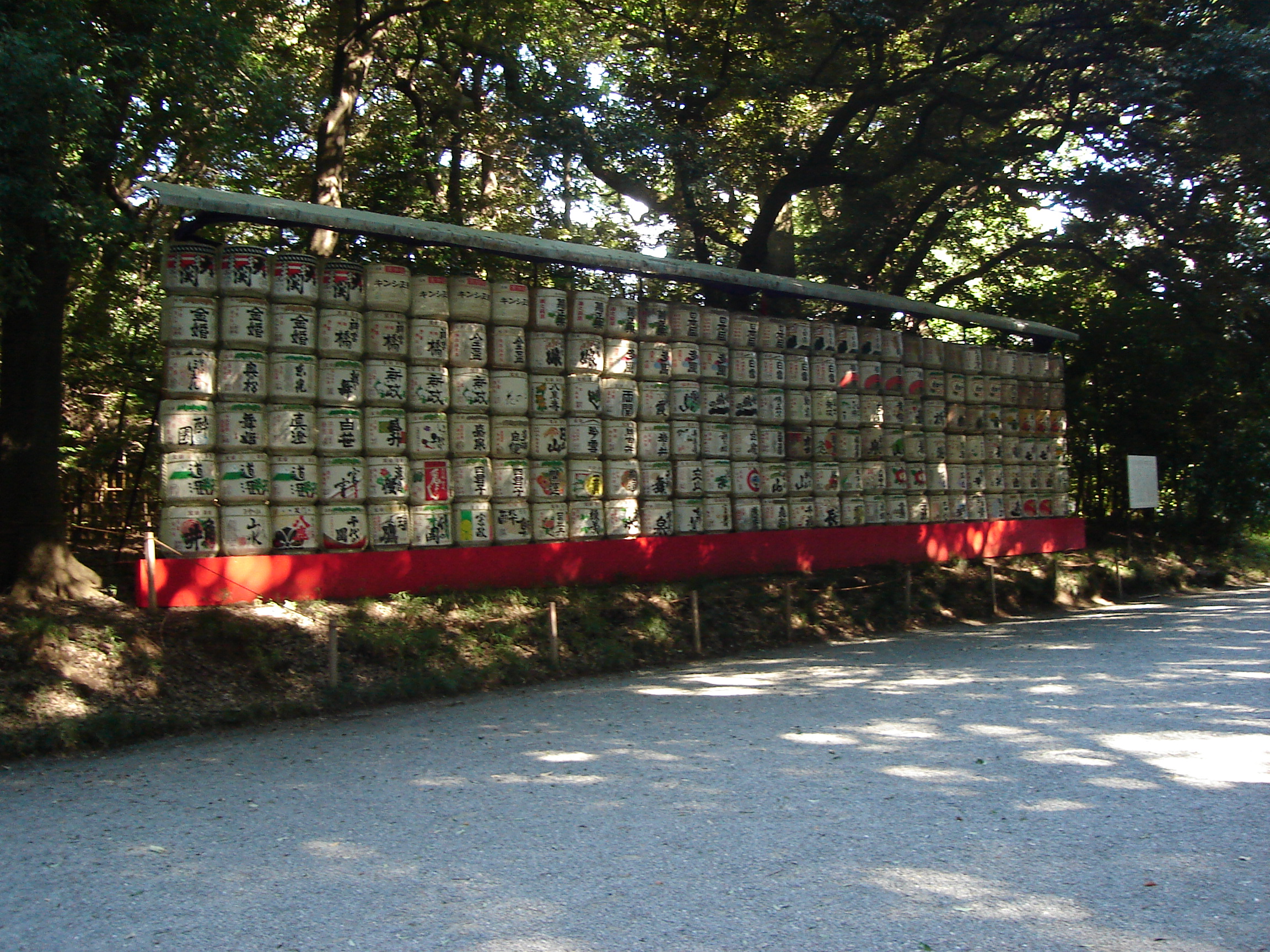 a display of barrels of donated sake with many colourful characters and symbols