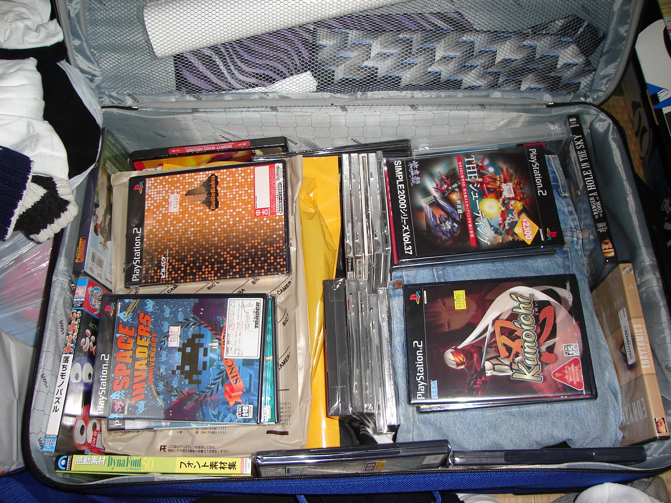 a suitcase stuffed full with video game cases