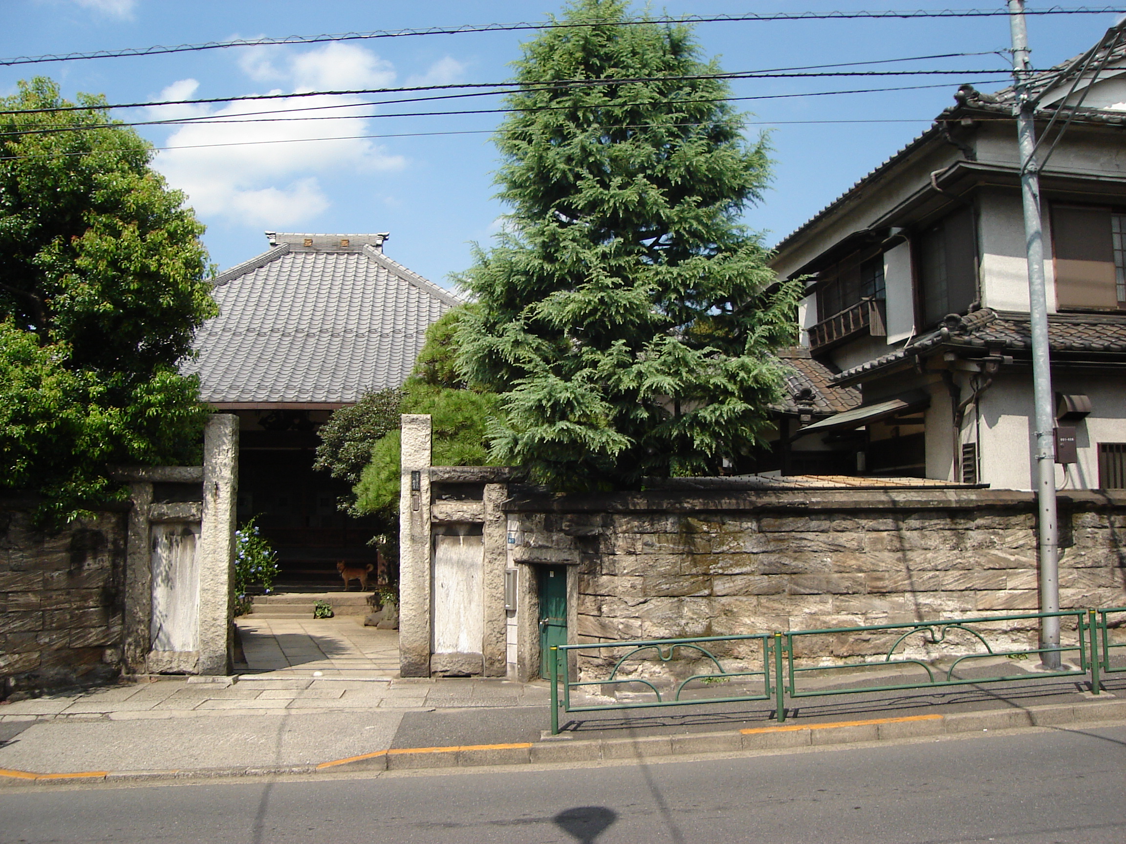 a traditional house behind a gated fence