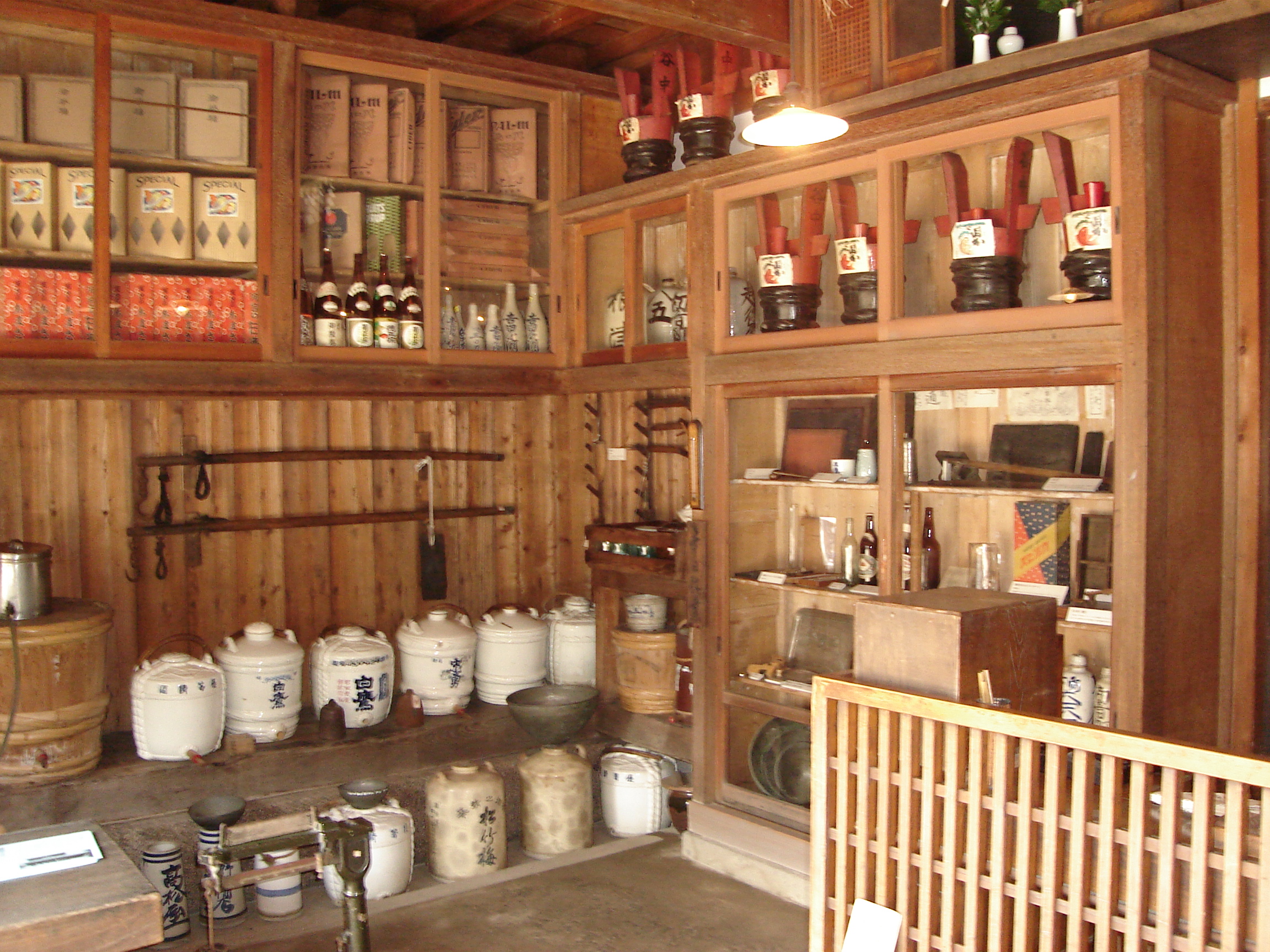 various ceramic pots and bottles on wooden shelves