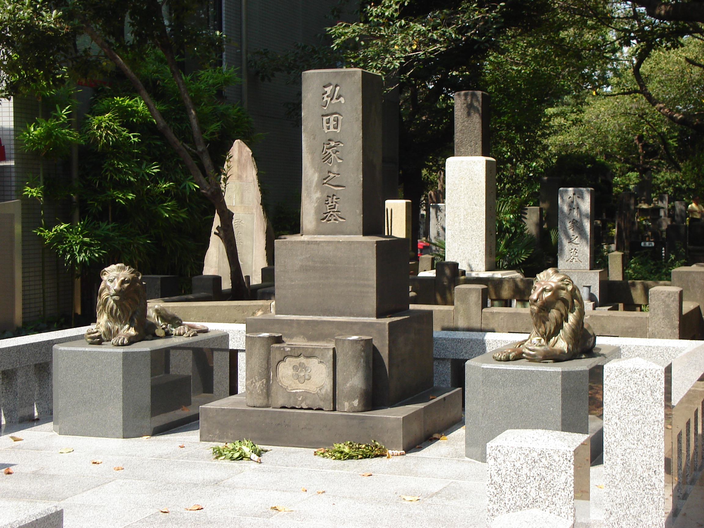 a large tiered gravestone flanked by lion statues