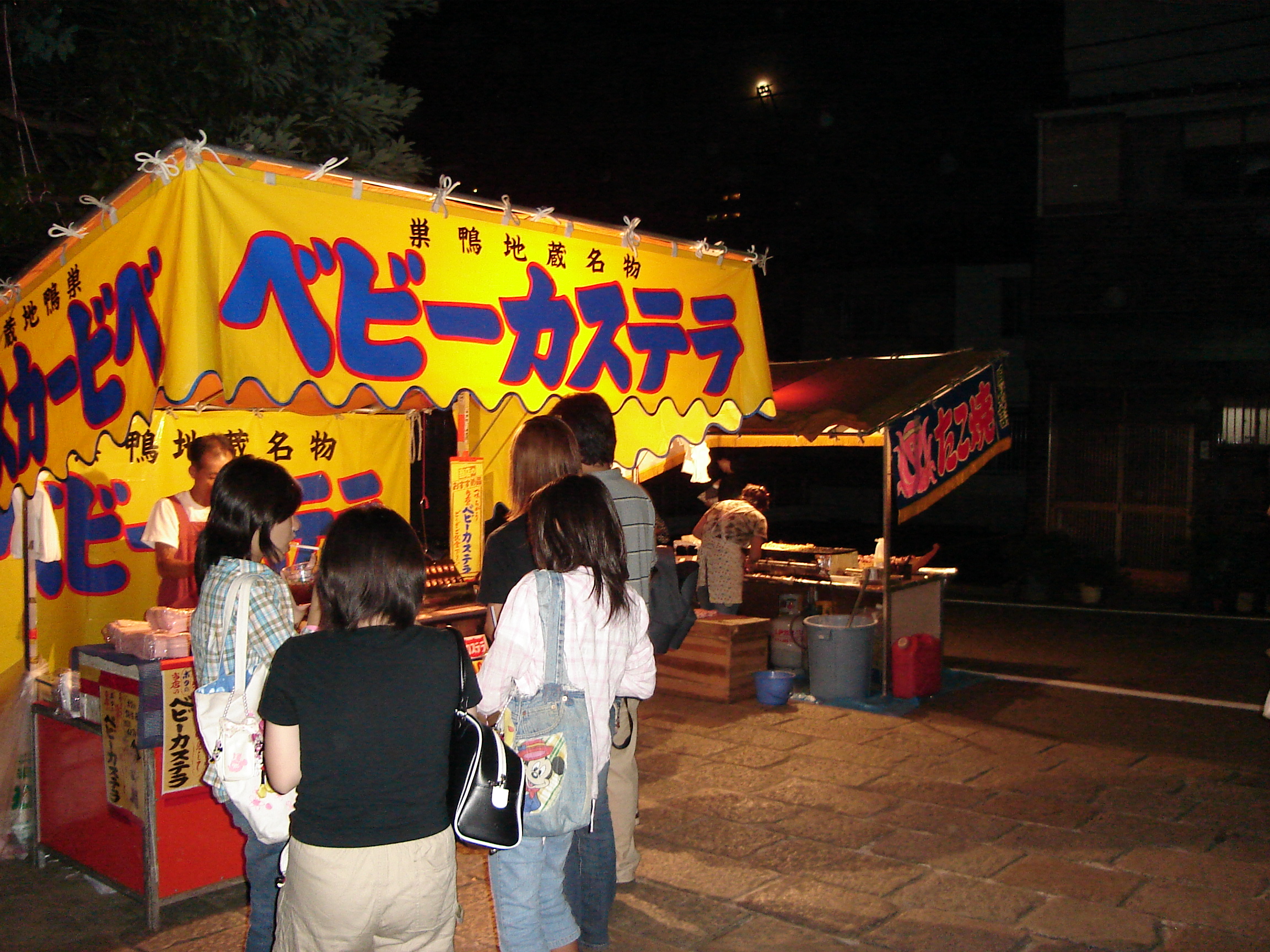 a food stall lit up at night