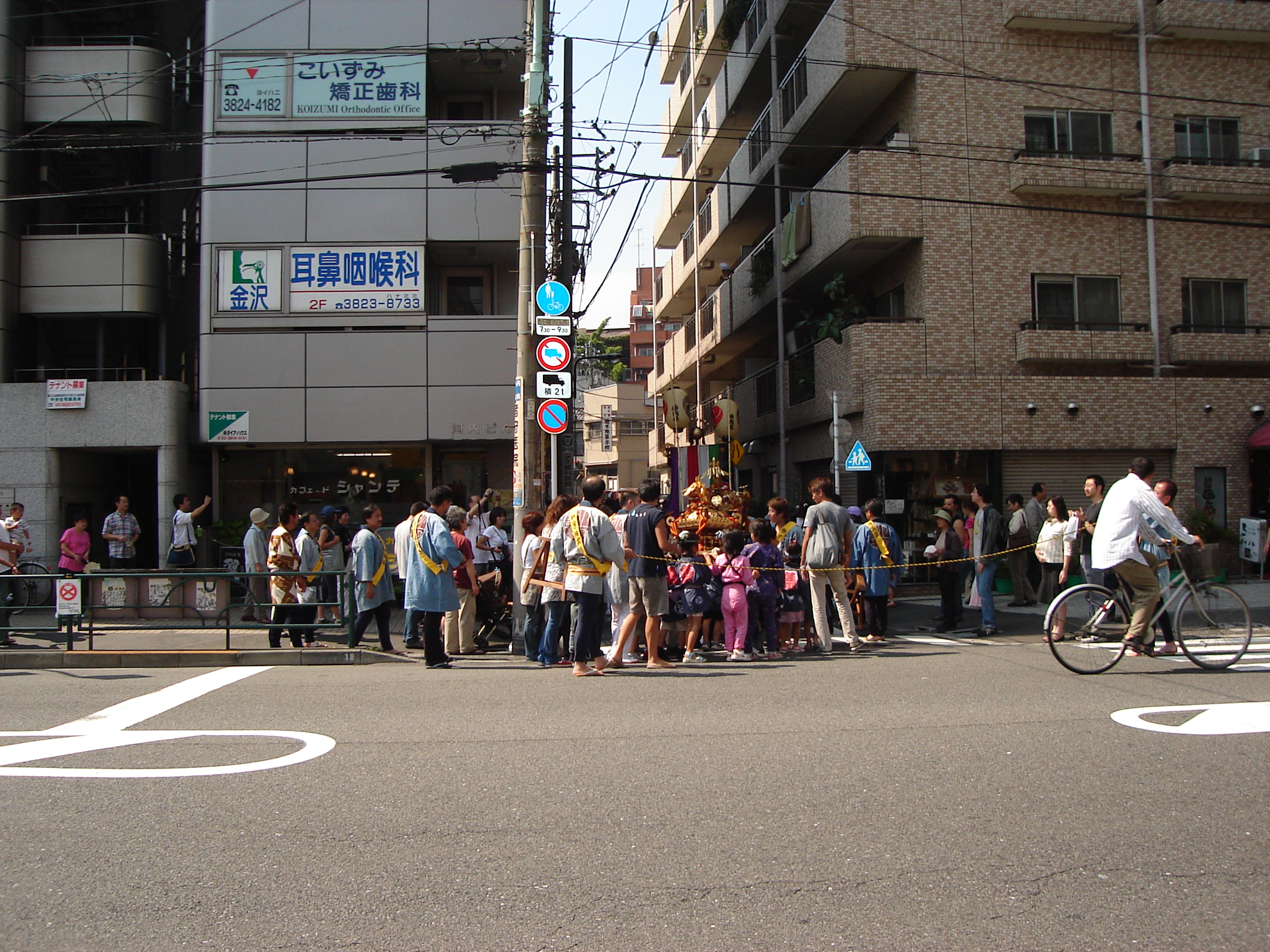 a procession of festival dressed people in daylight