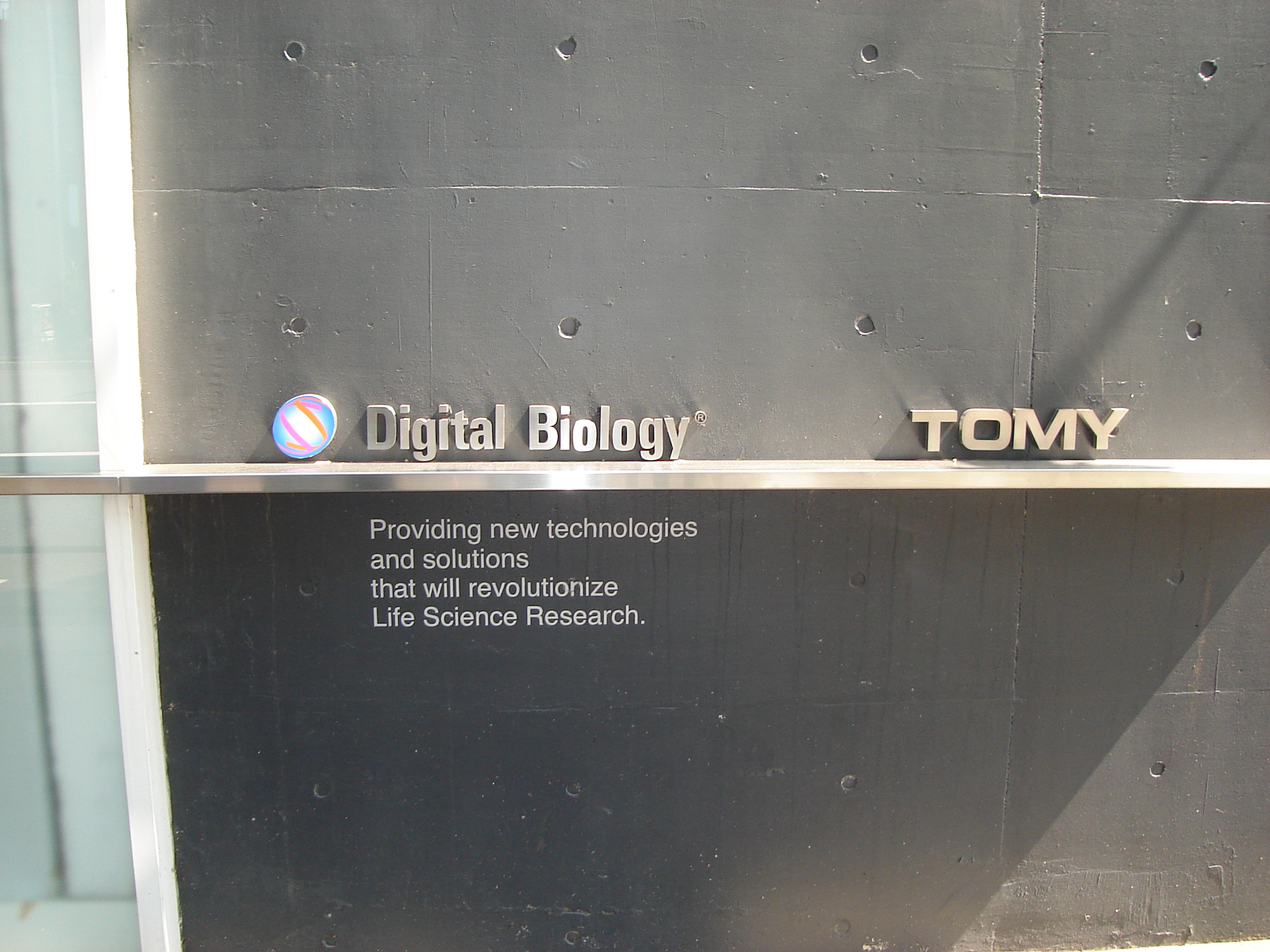 the Tomy digital biology building sign reads Providing new technologies and solutions that will revolutionize Life Science Research.
