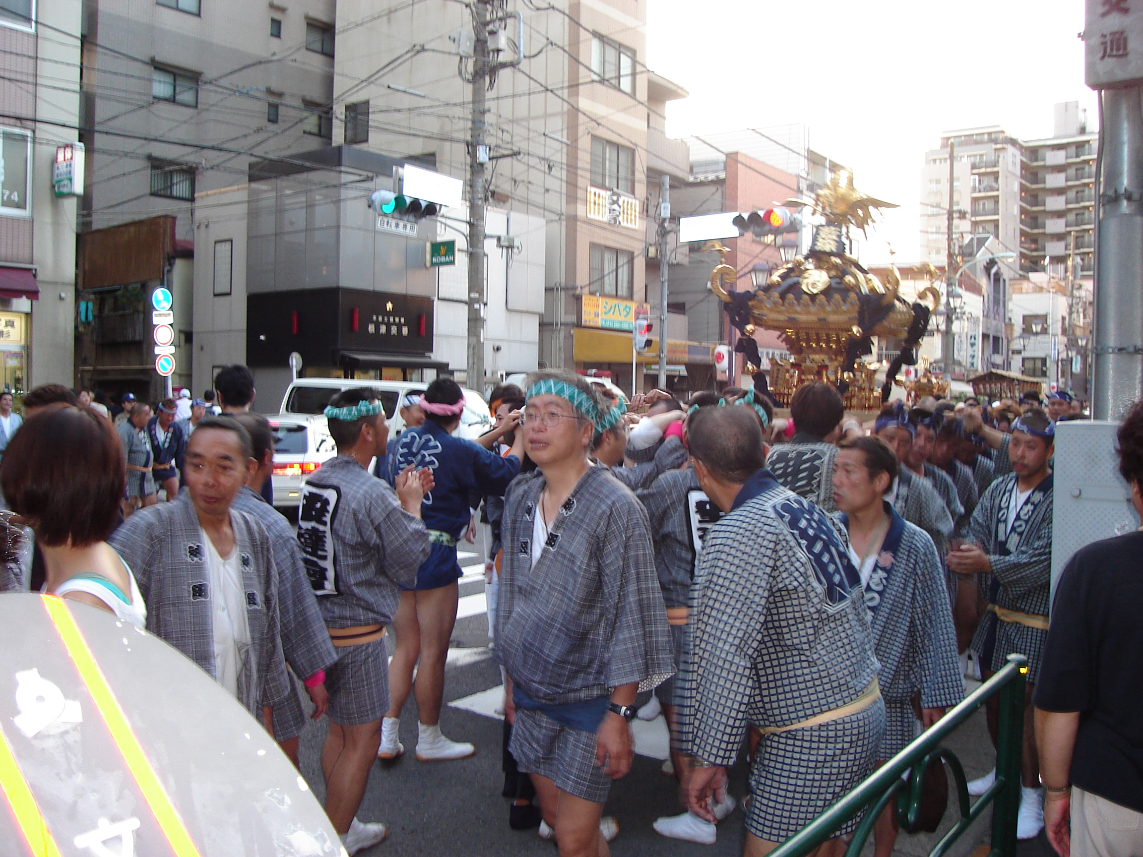 the procession continues along the side of the street
