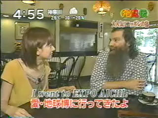 screenshot from a TV show with a woman interviewing Earl at a table.  There is text over the image that includes I went to expo aichi.