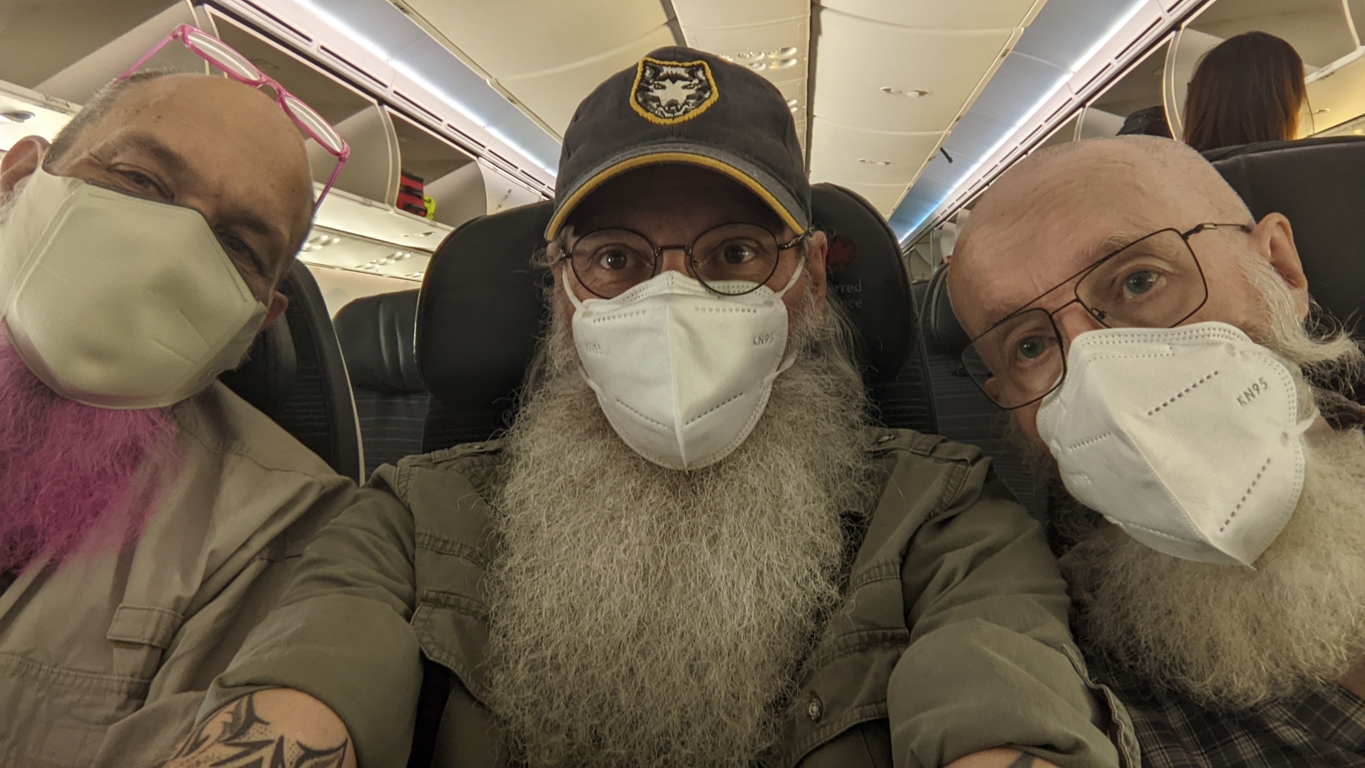 selfie of the three of us on the plane.  Les has a pink beard and we are all masked.