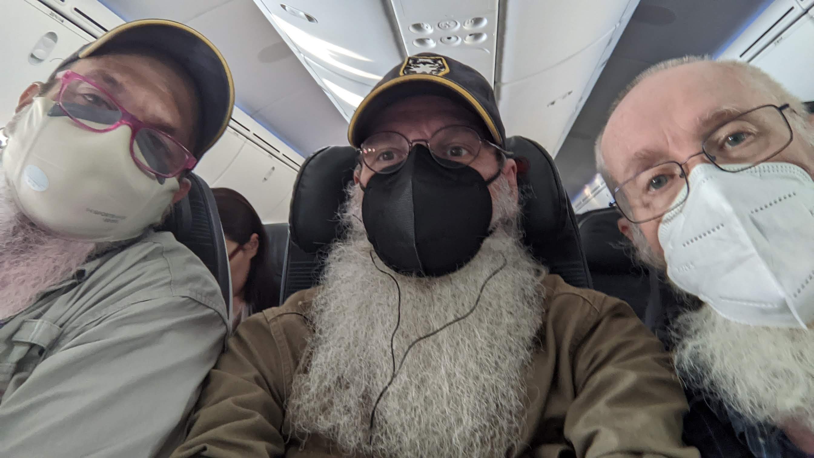 selfie of the three of us on the plane. We are all masked and Les' pink beard has faded a lot.