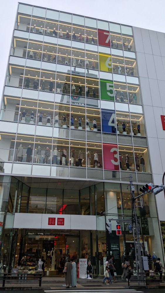 A Uniqlo store with large numbers on each floor from 3 to 7